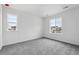 Bedroom with carpet flooring and two windows showing a neighborhood at 9297 Truckee Ct, Commerce City, CO 80022