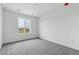 Bedroom featuring soft carpet and a large window overlooking the neighborhood at 9297 Truckee Ct, Commerce City, CO 80022