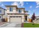 Inviting two-story home featuring a spacious driveway and beautifully landscaped front yard at 9297 Truckee Ct, Commerce City, CO 80022