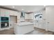 Contemporary kitchen with white cabinets, a center island, and built-in appliances at 9297 Truckee Ct, Commerce City, CO 80022