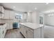 Bright modern kitchen with center island, stainless appliances, and ample counter space at 9297 Truckee Ct, Commerce City, CO 80022