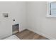 Laundry room with a tiled floor, window, and hookups for a washer and dryer at 9297 Truckee Ct, Commerce City, CO 80022