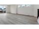 Spacious living room featuring light wood floors and sliding glass doors at 9297 Truckee Ct, Commerce City, CO 80022