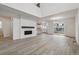 Bright living room with modern fireplace, tall ceilings, and an open floor plan at 9297 Truckee Ct, Commerce City, CO 80022