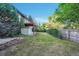 Landscaped backyard featuring mature trees, shed, deck, and brick retaining wall at 7018 Reed Ct, Arvada, CO 80003