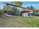 A view of the backyard, deck, shed, and brick patio at 7018 Reed Ct, Arvada, CO 80003