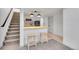 Basement bar area featuring a modern design, lighting, and barstool seating at 7018 Reed Ct, Arvada, CO 80003