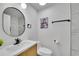 Updated bathroom with modern fixtures, vanity, round mirror, and Parisian decor at 7018 Reed Ct, Arvada, CO 80003