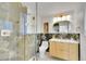 Modern bathroom featuring a glass shower, custom vanity, and neutral decor at 7018 Reed Ct, Arvada, CO 80003