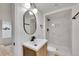 Updated bathroom featuring a modern vanity and tile shower at 7018 Reed Ct, Arvada, CO 80003