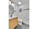 Bathroom with updated vanity, modern fixtures, oval mirror, and Paris art at 7018 Reed Ct, Arvada, CO 80003