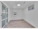 This bedroom features neutral carpet, white walls, and a closet with sliding doors at 7018 Reed Ct, Arvada, CO 80003