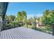 Large deck with metal railing overlooking mature trees and neighborhood at 7018 Reed Ct, Arvada, CO 80003