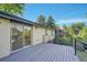 Open deck with metal railing, access to sliding door, and brick exterior at 7018 Reed Ct, Arvada, CO 80003