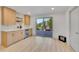 Dining room with wood cabinets, wine fridge, and views at 7018 Reed Ct, Arvada, CO 80003