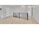Hallway with modern black metal railings, and updated lighting at 7018 Reed Ct, Arvada, CO 80003