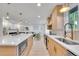 Modern kitchen featuring a center island, stainless steel appliances, and an open layout into the living area at 7018 Reed Ct, Arvada, CO 80003