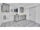 Laundry room with cabinets, black and white patterned tile, and a sink with modern fixtures at 7018 Reed Ct, Arvada, CO 80003