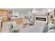 Open-concept living space with a modern kitchen, cozy living room area, and a stylish fireplace at 7018 Reed Ct, Arvada, CO 80003