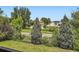 Green backyard view showcasing lush landscaping and beautiful, mature trees providing lots of privacy at 7863 W Friend Dr, Littleton, CO 80128
