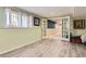 Finished basement featuring luxury vinyl plank flooring and double doors leading to another space at 7863 W Friend Dr, Littleton, CO 80128