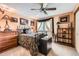 This bedroom offers carpeted floors, a ceiling fan, a window with blackout curtains, and closet space at 7863 W Friend Dr, Littleton, CO 80128
