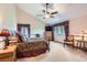 Comfortable bedroom with vaulted ceilings and a ceiling fan and two windows with curtains at 7863 W Friend Dr, Littleton, CO 80128