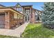 Charming Tudor home with brick accents and a well-manicured lawn and garden at 7863 W Friend Dr, Littleton, CO 80128