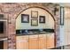 Cozy kitchen with brick arch over a gas cooktop and granite countertops at 7863 W Friend Dr, Littleton, CO 80128