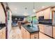 Open-concept kitchen featuring granite counters and stainless steel appliances with island at 7863 W Friend Dr, Littleton, CO 80128