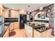 Bright kitchen featuring granite countertops, stainless steel appliances, and a brick archway at 7863 W Friend Dr, Littleton, CO 80128