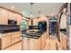 Updated kitchen with granite countertops, wood cabinets, and stainless steel appliances at 7863 W Friend Dr, Littleton, CO 80128