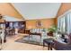 Bright living room with vaulted ceilings, hardwood floors, and an adjacent dining area at 7863 W Friend Dr, Littleton, CO 80128