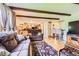 Open living space with an open view of the kitchen. Cozy sofas and wooden ceilings beams at 7863 W Friend Dr, Littleton, CO 80128