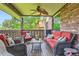 Covered porch featuring comfortable wicker furniture and a ceiling fan for outdoor relaxation at 7863 W Friend Dr, Littleton, CO 80128