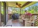 Relaxing covered porch with patio furniture, a grill, and a fun flamingo statue at 7863 W Friend Dr, Littleton, CO 80128