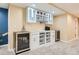 The custom wet bar offers custom glass front cabinetry and wine refrigerators at 7863 W Friend Dr, Littleton, CO 80128