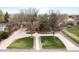 Overhead view of a home with a spacious driveway and lawn, surrounded by mature trees at 435 Balsam St, Lakewood, CO 80226