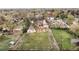 A high-angle view of the property and its surroundings, mature trees, and grassy backyard at 435 Balsam St, Lakewood, CO 80226