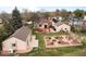 An aerial view of the home shows the deck, large garden, mature trees, and outbuilding at 435 Balsam St, Lakewood, CO 80226