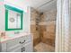 Bathroom featuring shower stall with tiled walls, updated fixtures, and large vanity at 435 Balsam St, Lakewood, CO 80226