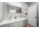 Bright bathroom featuring a dual sink vanity and modern fixtures, with a window offering natural light and ventilation at 435 Balsam St, Lakewood, CO 80226