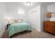 Cozy bedroom featuring neutral carpet, a double closet, and simple decor at 435 Balsam St, Lakewood, CO 80226
