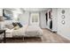 Bright bedroom with neutral carpet, natural lighting, and closet with ample storage at 435 Balsam St, Lakewood, CO 80226