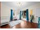 Bright bedroom with hardwood floors, large windows with lush curtains, and stylish decor, creating a cozy atmosphere at 435 Balsam St, Lakewood, CO 80226