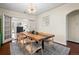 Bright dining room with a large wooden table and seating for six, next to a room with French doors at 435 Balsam St, Lakewood, CO 80226