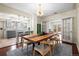 Dining room with wooden table, seating for six, and a view to the kitchen and outdoor patio at 435 Balsam St, Lakewood, CO 80226