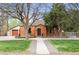 Charming brick home with a well-manicured lawn and mature trees in a desirable neighborhood at 435 Balsam St, Lakewood, CO 80226
