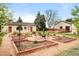 Unique garden with brick borders and a fire pit, set against the backdrop of outbuildings at 435 Balsam St, Lakewood, CO 80226