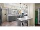 Modern kitchen with updated appliances, gray cabinets, and a breakfast bar with seating for two at 435 Balsam St, Lakewood, CO 80226
